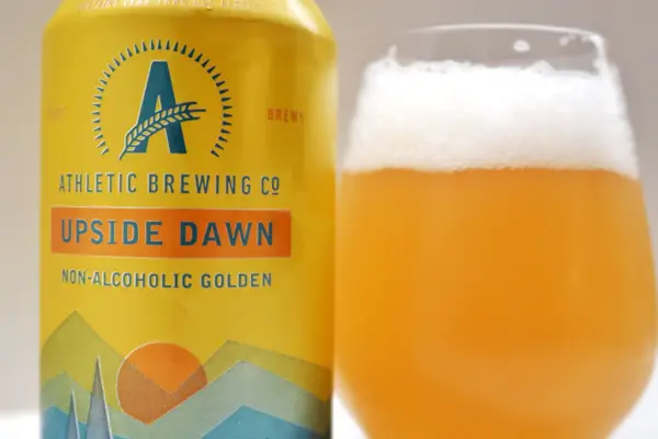 Upside Dawn Golden Ale - Athletic Brewing Co poured in Glass