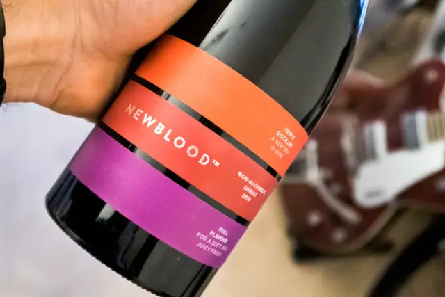 Newblood Shiraz Bottle with guitar in the backgrounde