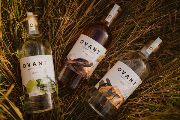 Ovant distillery range of spirits in a field of hay
