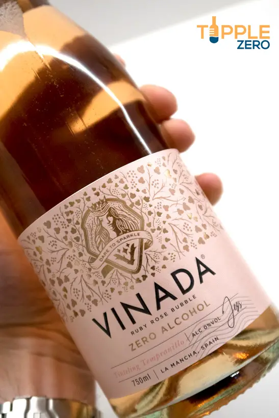 Vinada non alcoholic rose wine front of bottle in hand