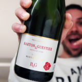 Barton and Guestier Blanc Non Alcoholic Sparkling in hand held at camera
