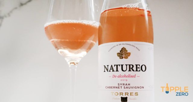 Natureo Rose Bottle in front of poured glass of wine