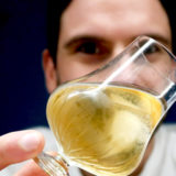 Glass of feragaia in front of male who is holding it