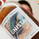 Gnista Floral Wormwood bottle held out in front of person