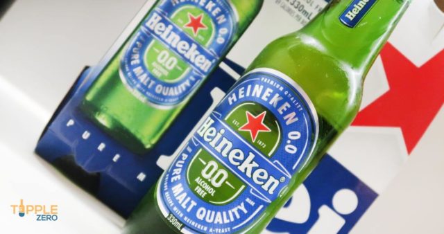 Heineken Zero Bottle on Bench in front of retail packaging