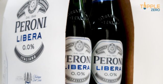 Peroni libera zero non-alcoholic lager bottles in retail packaging on bench