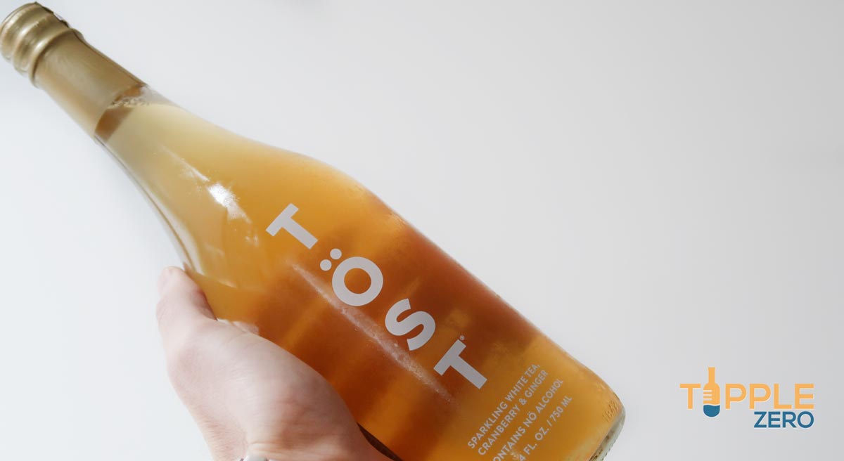 Tost Non-Alcoholic Sparkling bottle in hand