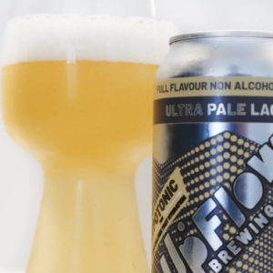 UpFlow Ultra Pale Lager Can and Glass containing beer on Bench