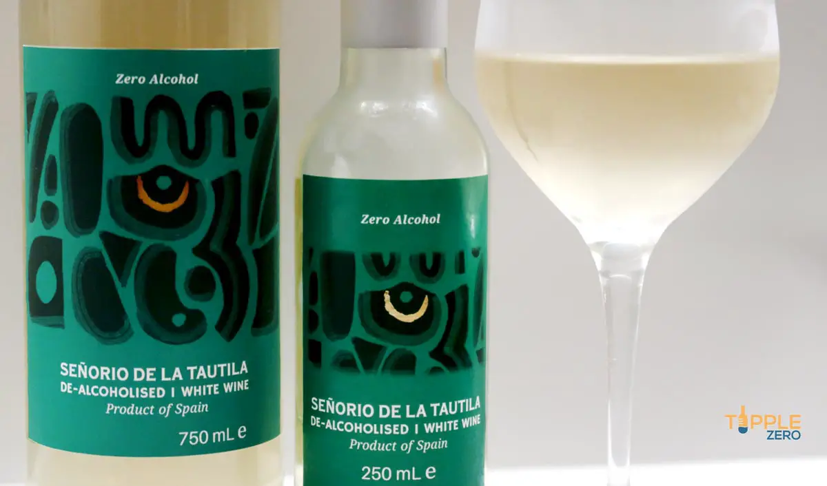 De La Tautila White Wine Bottles large bottle and small bottle next to glass of wine