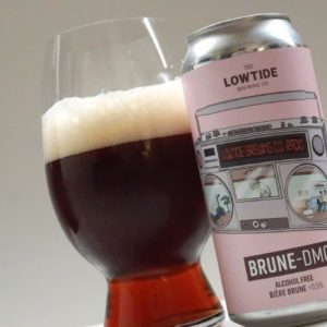 Lowtide Brewing Brune DMC can next to glass full showing brown colour of beer