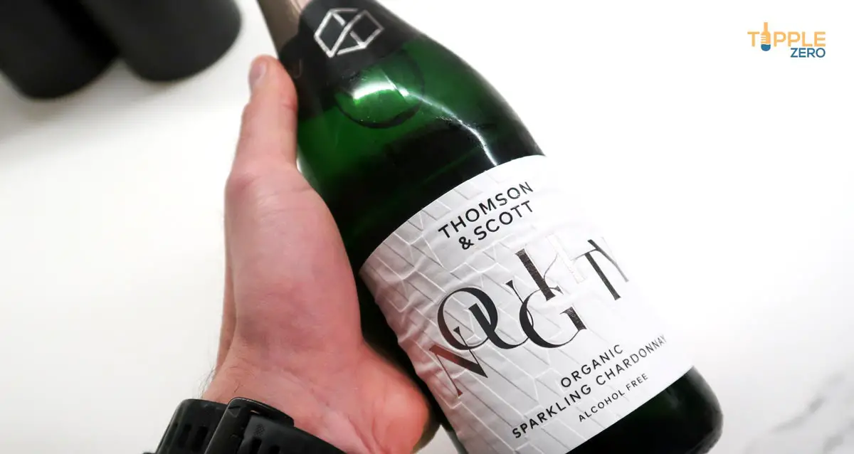 thomson and scott noughty Non-Alcoholic Wine sparkling bottle front in hand