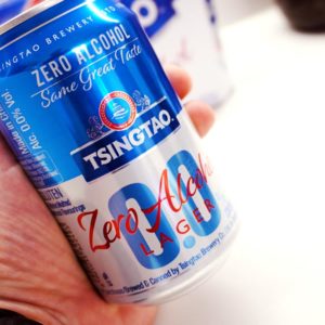 Tsingtao 0.0 Zero Alcohol Lager can showing label in hand