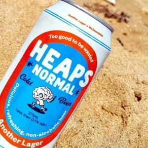 Heaps Normal Another Lager can in sand