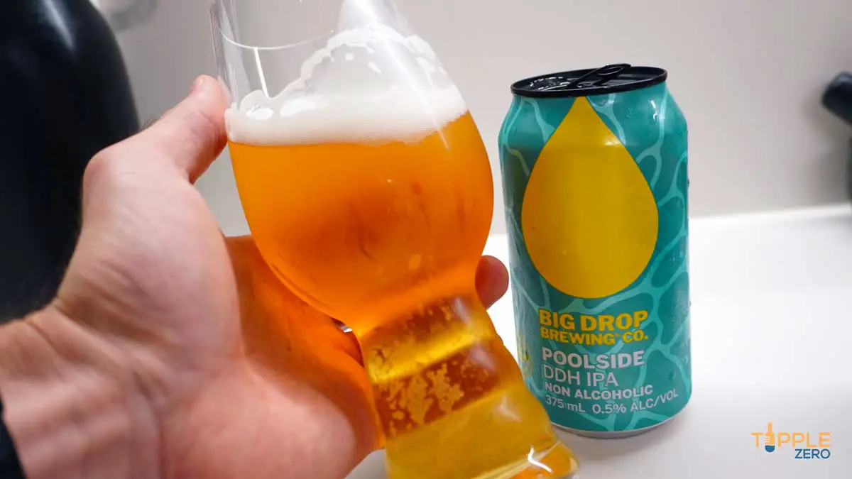 Big Drop Poolside DDH Poured in glass and held in hand showing colour