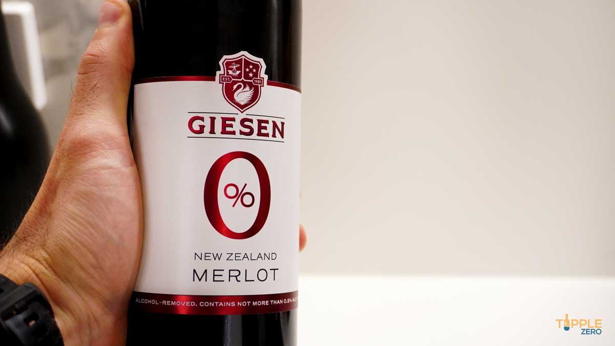 Alcohol free Giesen 0% Merlot bottle showing label in hand
